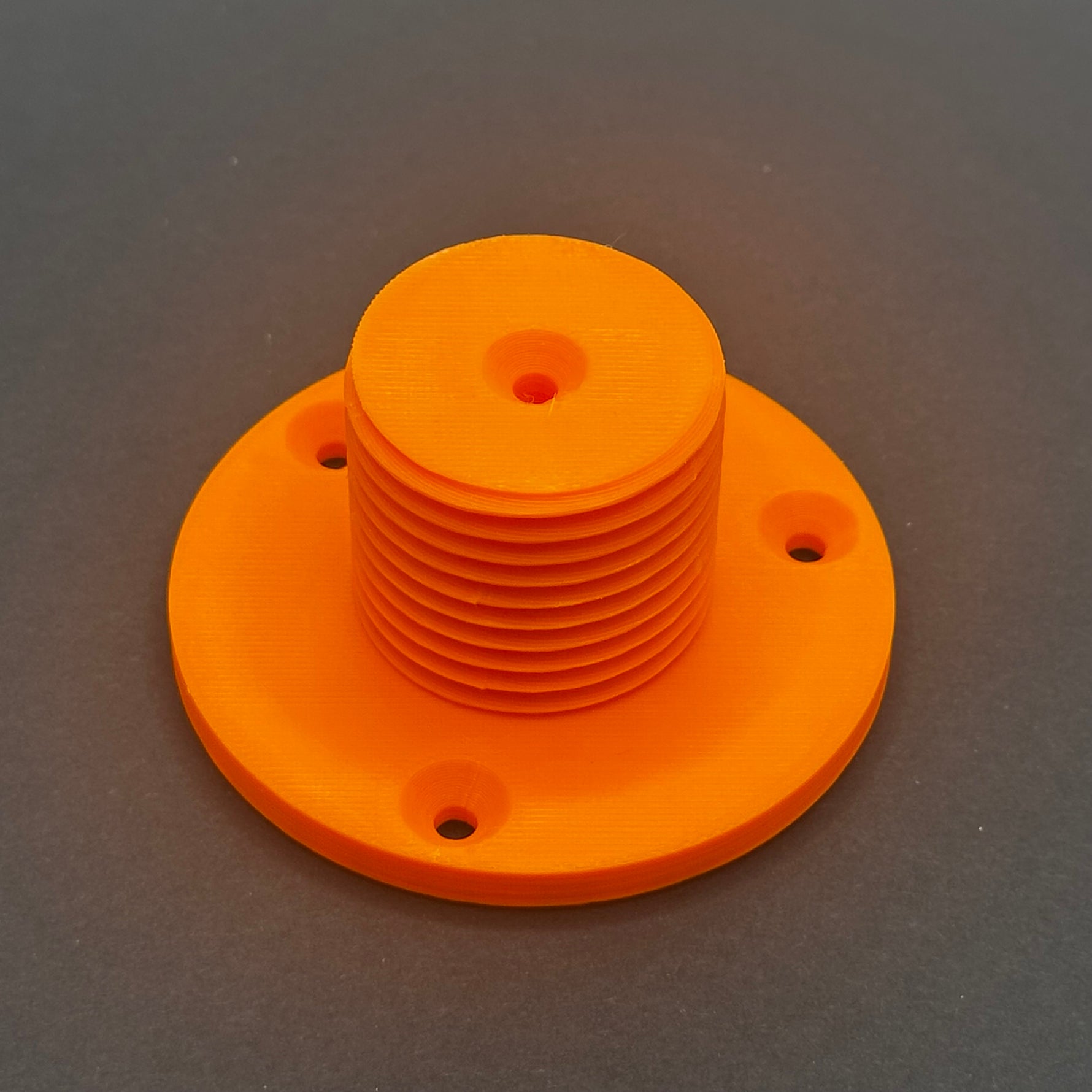 3D printed lathe chuck holder mounted on workshop wall