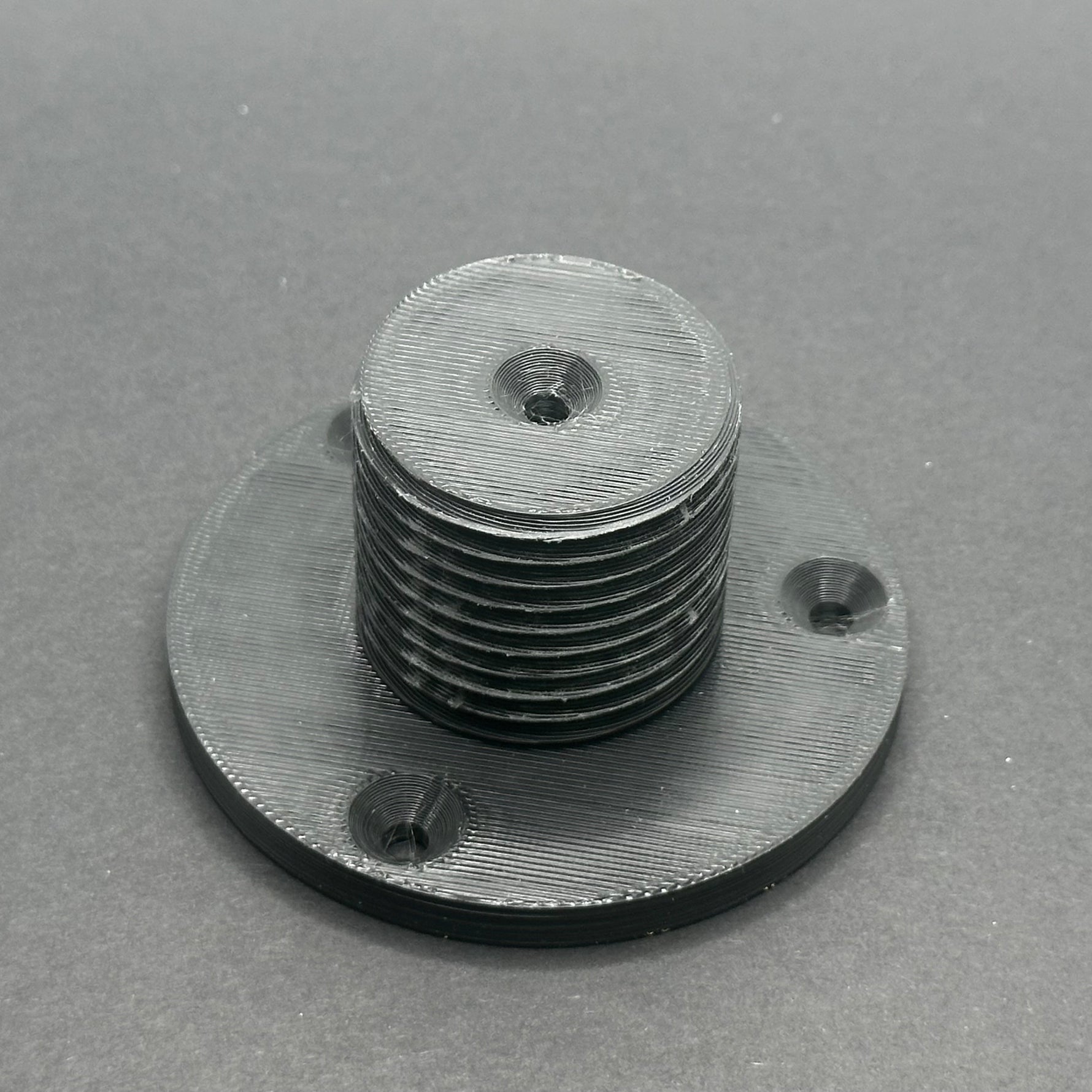 3D printed lathe chuck holder mounted on workshop wall