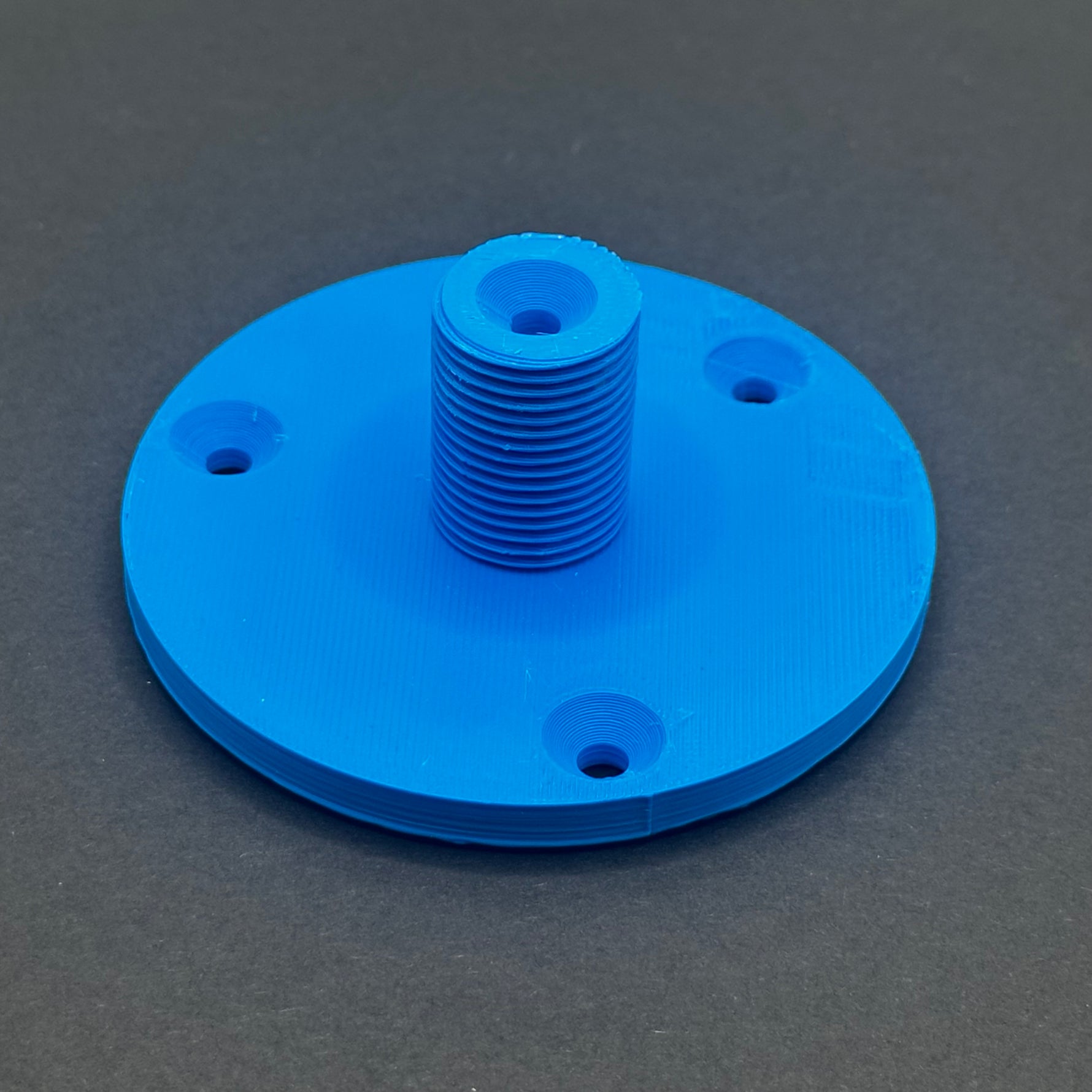 3D printed lathe chuck holder mounted on workshop wall