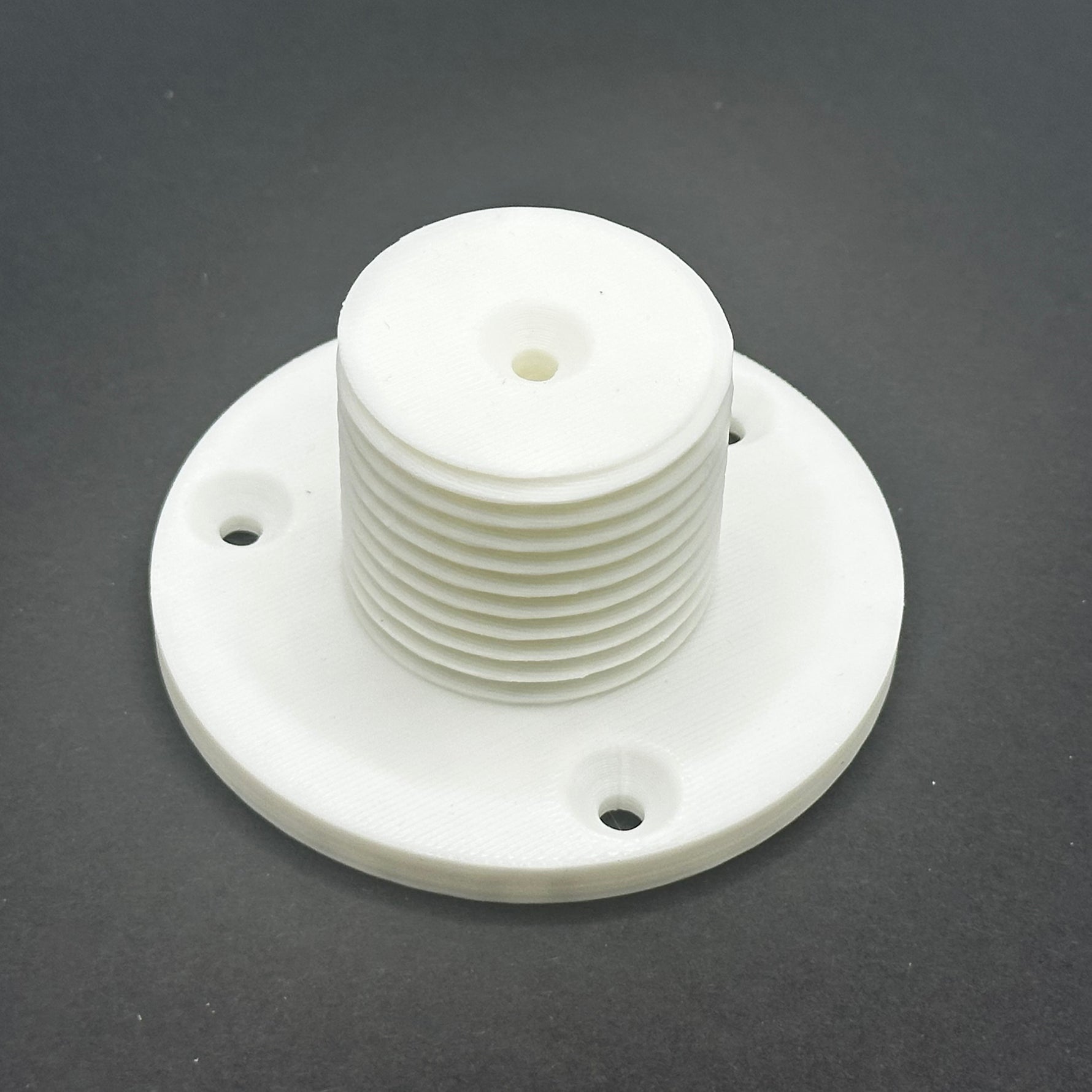 3D printed lathe chuck holder mounted on workshop wall