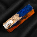 Hybrid burl call blank BC-0001 featuring vibrant blue glitter resin and warm orange tones over natural wood grain
