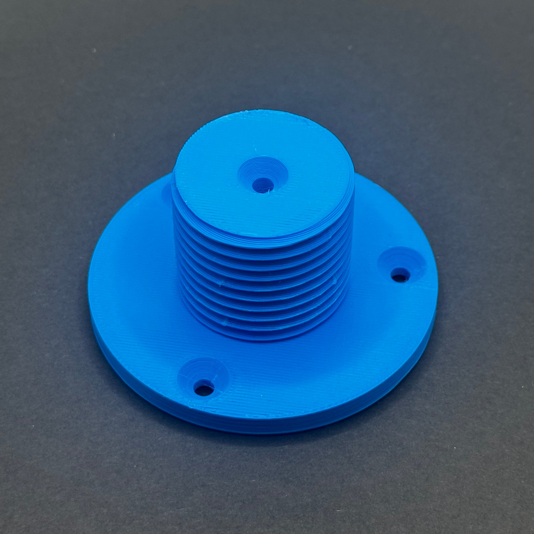 3D printed lathe chuck holder mounted on workshop wall