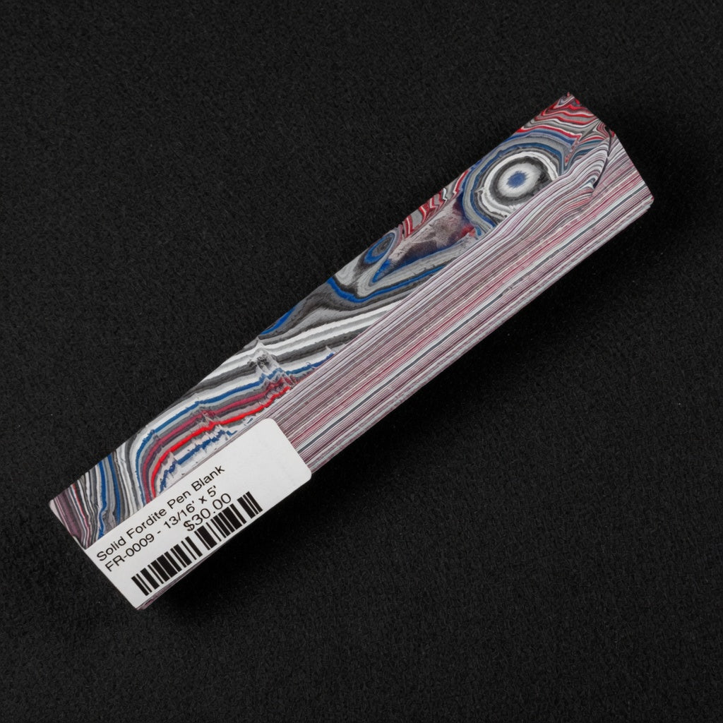 Solid Fordite pen blank FR-0009 displaying vibrant red, blue, and gray layered paint patterns from decades of factory overspray