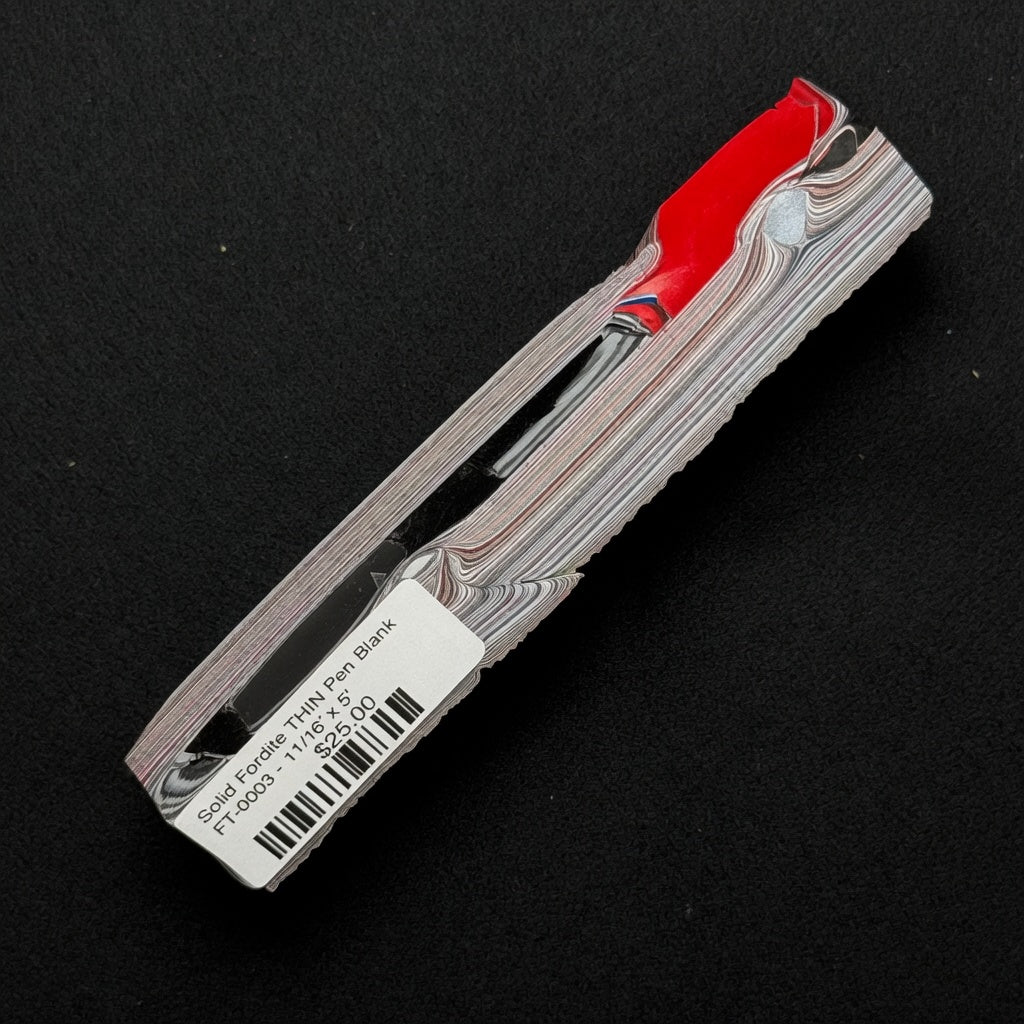 Solid Fordite pen blank FT-0003 displaying bold red layers over black, white, and gray striped patterns