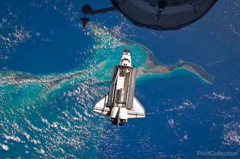 The space shuttle Atlantis is seen over the Bahamas prior to a perfect docking with the International Space Station