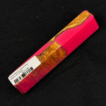 Vibrant pink resin surrounds rich olive wood burl with warm orange, brown and yellow tones on pen blank OH-0004